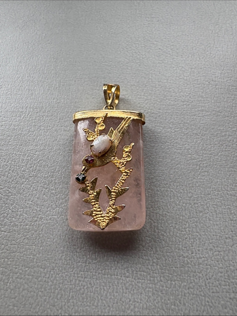 Ornate Asian bird pendant on pink quartz.